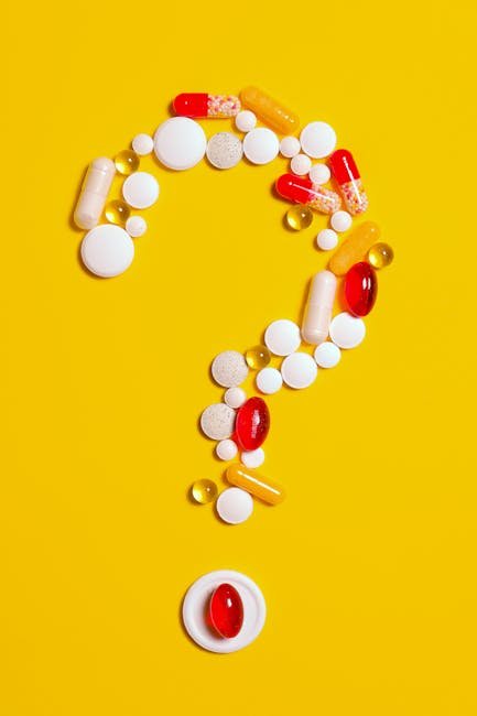 A creative arrangement of various pills forming a question mark against a bright yellow background.